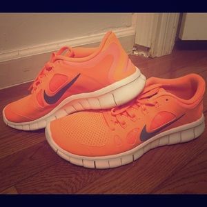 Orange Nike free runs