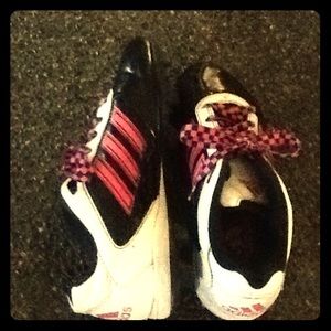 Pink and black soccer/softball cleats.