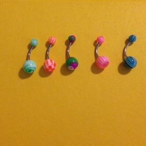 5 multicolored belly button rings.