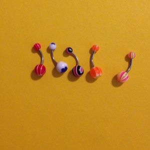 5 multicolored belly button rings.
