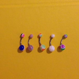 5 multicolored belly button rings.