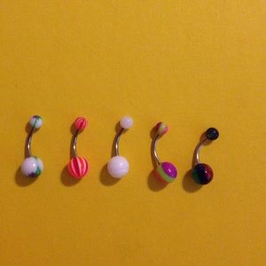 5 multicolored belly button rings.