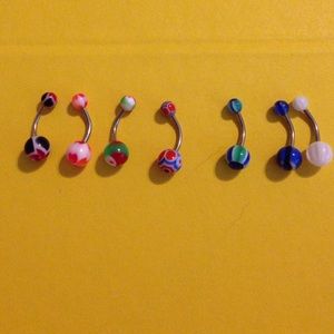 7 multicolored belly button rings.
