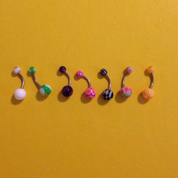 7 multicolored belly button rings.