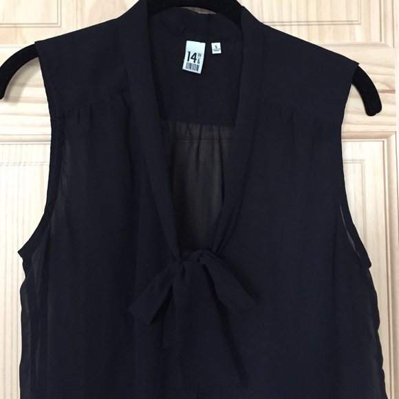 Sleeveless sheer black top.