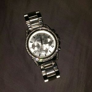 Silver watch with rhinestone details.