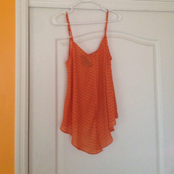 Orange tank with blue polka dots. Tie in the front