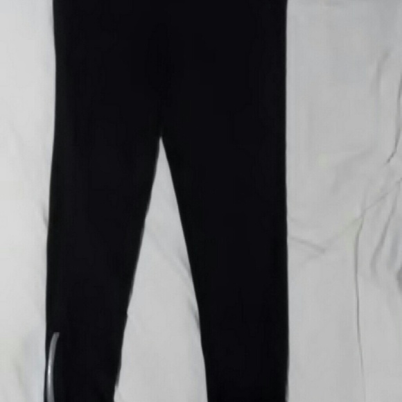 Black yoga pants, zipper bottoms.