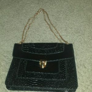 Black purse with gold chain handle
