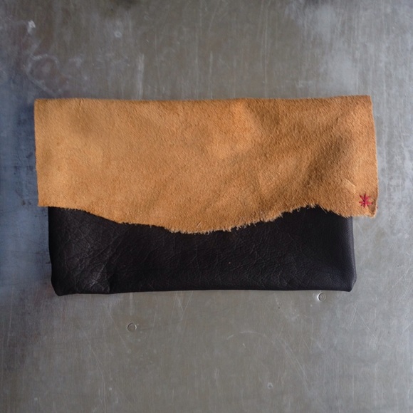 HANDMADE reversible leather clutch.