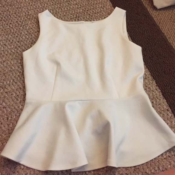 Sleeveless white flowy tank.