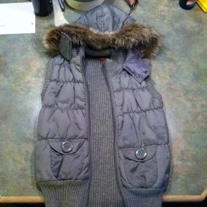 gray puffy vest with fur hood