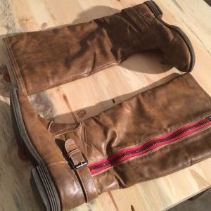 Tan boots with red striped zipper