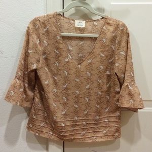 tan colored shirt with doves