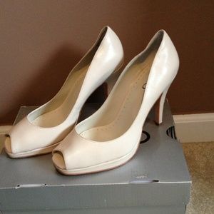 Cream peep toe pumps.