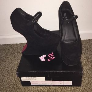 Black suede heel-less wedges/pumps.