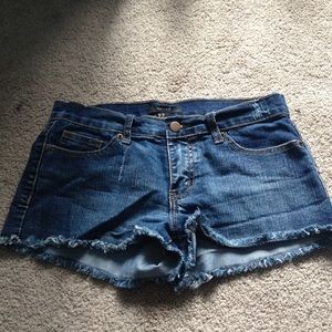 Dark wash shorts.