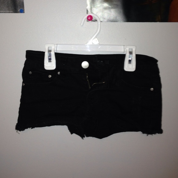 black short shorts. denim, ripped.