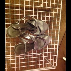 Silver open toe sling backs.