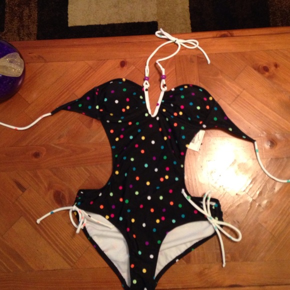Black bathing suit with multi colored polka dots.