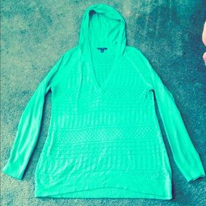 Hooded teal sweater.