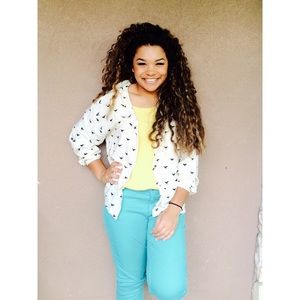 Cream blouse with birds on them.