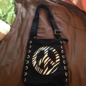 Small black purse with zebra peace sign on front