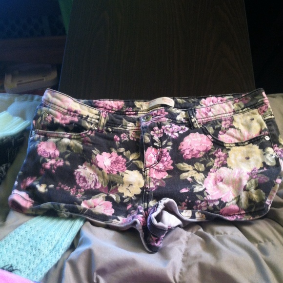 Black floral print denim shorts.