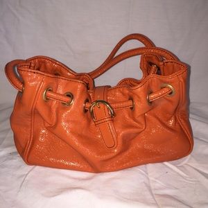 Orange cinch shiny bag with buckle