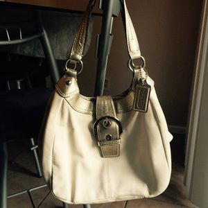 Cream colored coach purse with gold handles