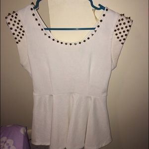 White blouse , with gold studs