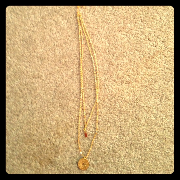 Gold initial bar necklaces.