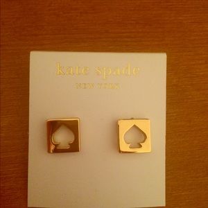 Gold Kate Spade stud earrings and white bangle