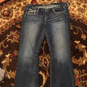 Distressed jeans with sequins and stitching