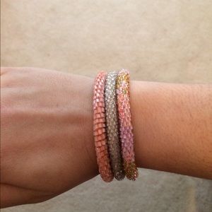 Stack of three pink beaded bracelets