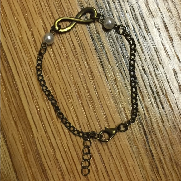 Bronze infinity bracelet with faux pearls