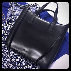 Cole Haan black purse with cross body strap.