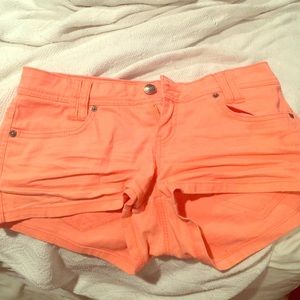 Bright pink or salmon colored shorts