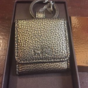 Metallic gold Coach keychain.