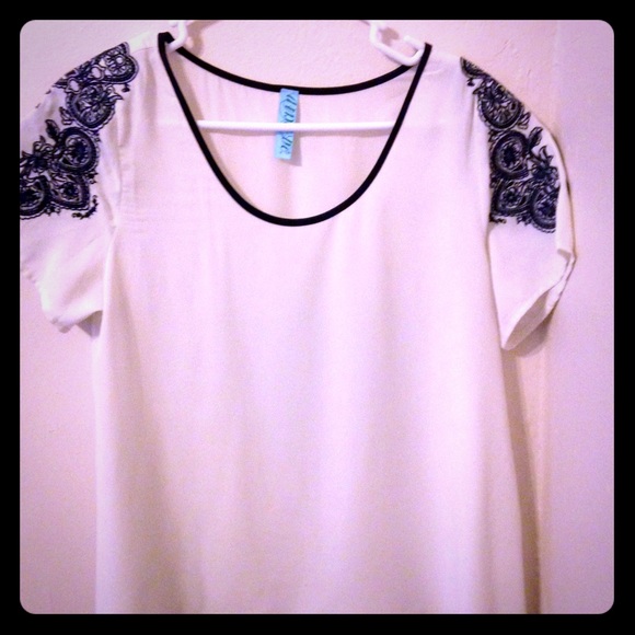 White blouse with navy shoulder detail