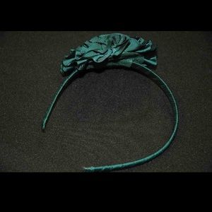 Green headband with flower.