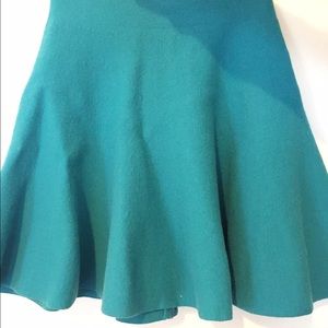 Peacock green short skirt.