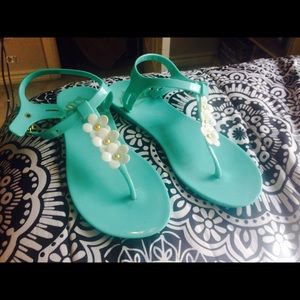 blue sandals with white flowers by: Fergie