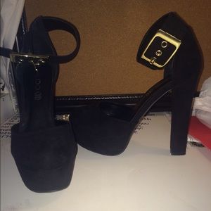Black heels with gold buckle