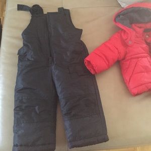Black snow pants and red winter coat