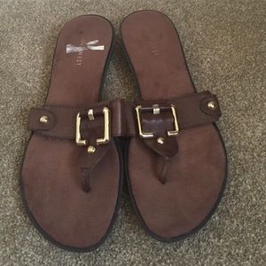 Brown and gold flip flop shoes