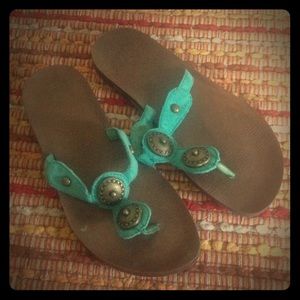 Teal sandals with antique brass-colored detail