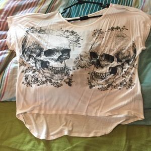 Lose fitting skull shirt with cross out in back.