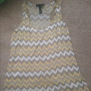 Grey , yellow , white top