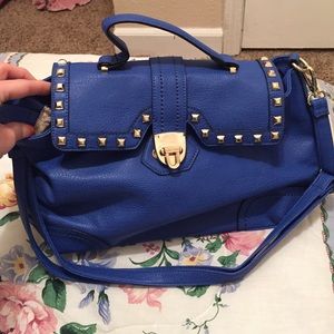 royal blue handbag with shoulder strap.